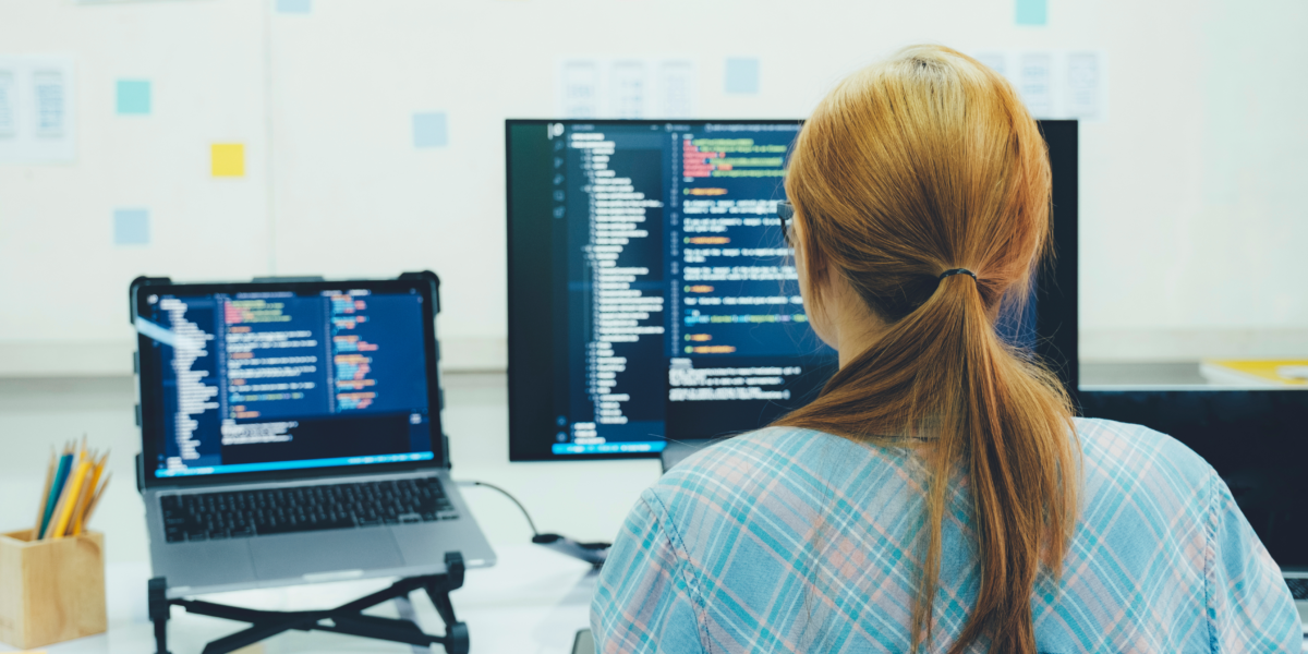 Woman coding using OOP on a computer