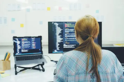 woman coding on computer