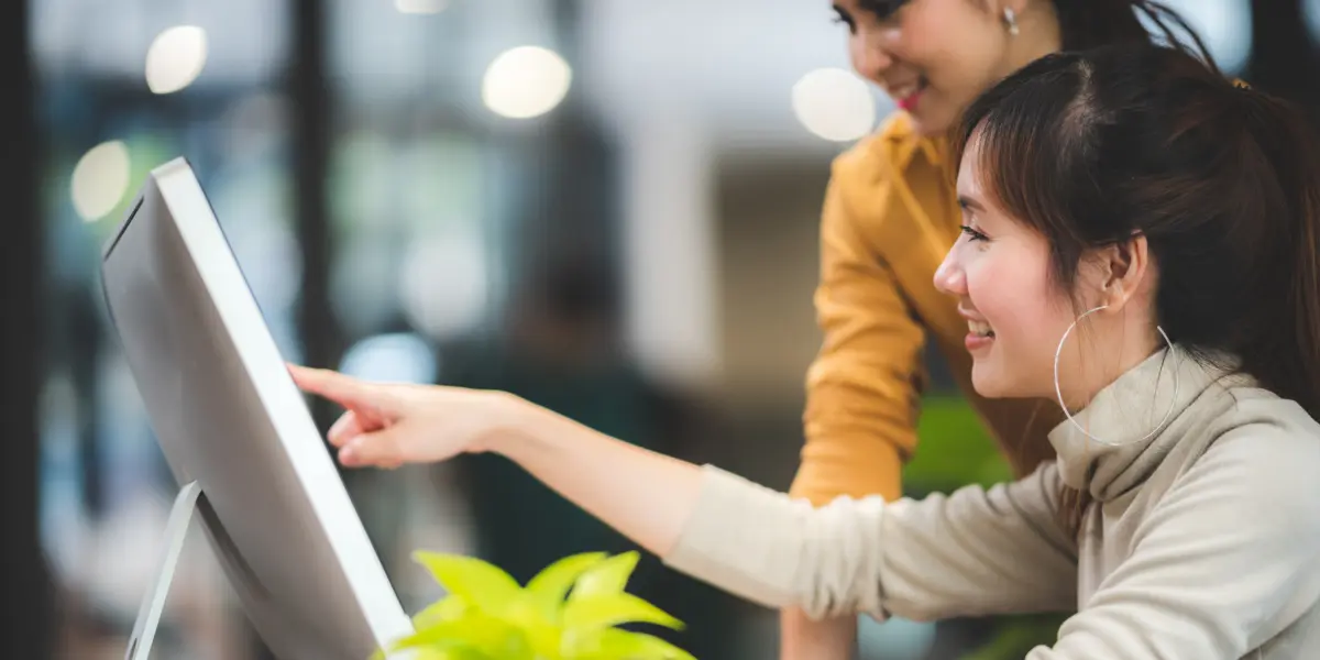 Two woman looking at a computer screen